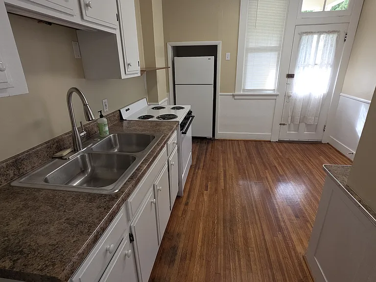 Kitchen has stove and refrigerator