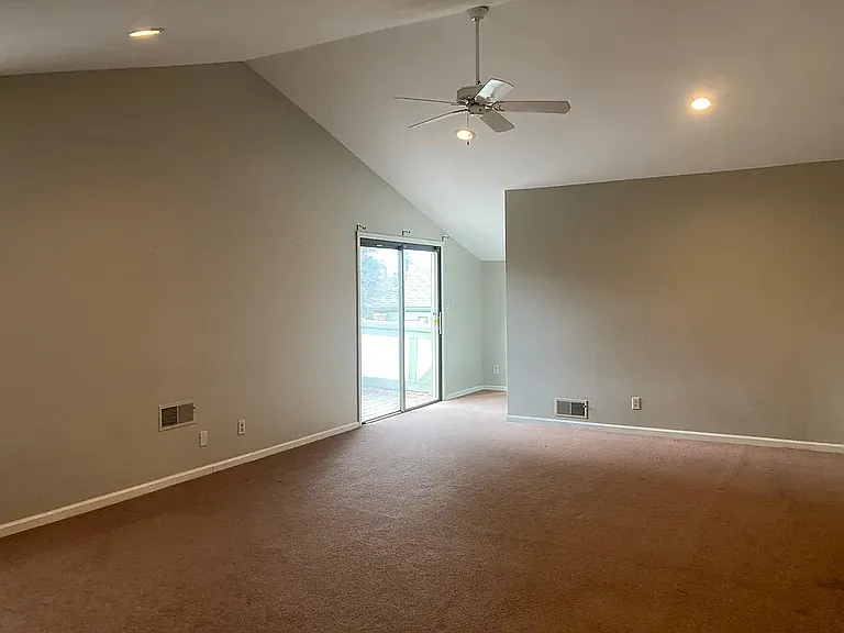 Spacious primary retreat featuring vaulted ceilings, fireplace, and abundant natural light.