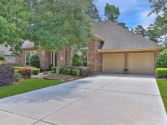 This is a wide driveway for ample parking. The garage is a 3-car tandem.