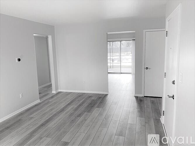 Living room with view into kitchen and slider to patio.