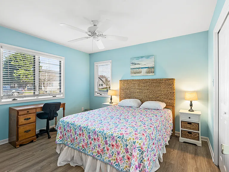 Guest bedroom with queen bed and desk for home office and remote-work located on the first floor
