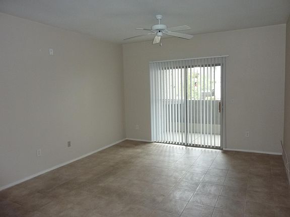 Large Living Room with tile flooring and ceiling fan.