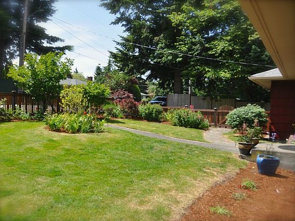 Enter through the lovely fence into the charming gardens.  Welcome home!