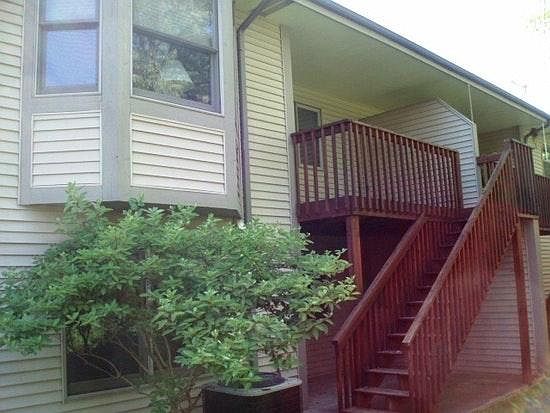 Ground level unit with lower walkout. Picture shows the balcony on entry level and walk out below. Rear of unit.