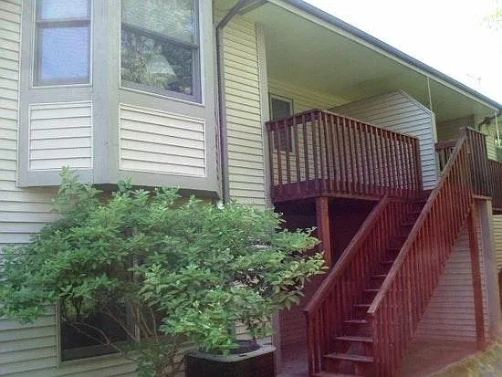 Ground level unit with lower walkout. Picture shows the balcony on entry level and walk out below. Rear of unit.