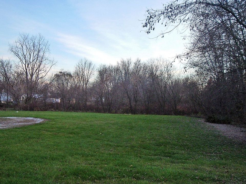 Property extexnds beyond tree line in back.