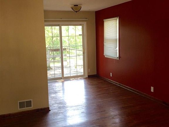 Dining area off kitchen with access to upper deck from sliding doors.