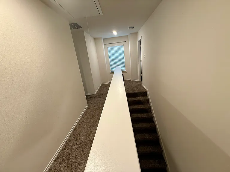 Stairs and upstairs walkway, looking towards guest bedroom #1 on the left and the master bedroom on the right