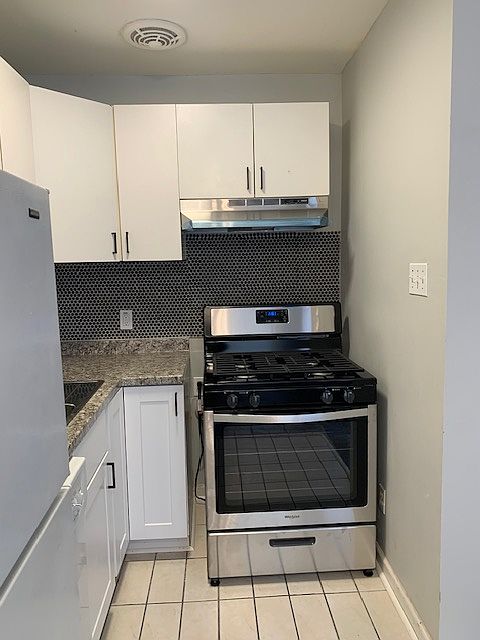 New stove, hood vent, counters, backsplash, and lower cabinets