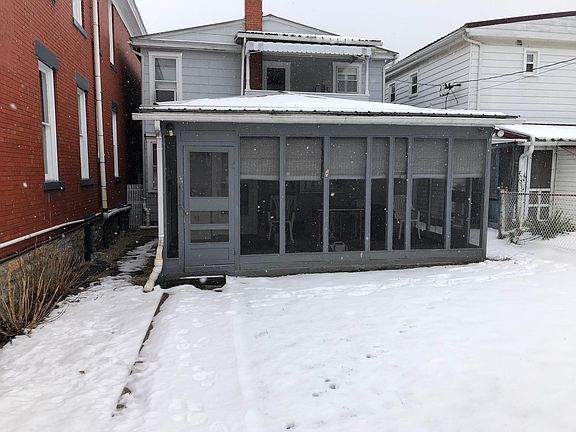 Rear door leads into screened porch, mail is delivered into slot here.