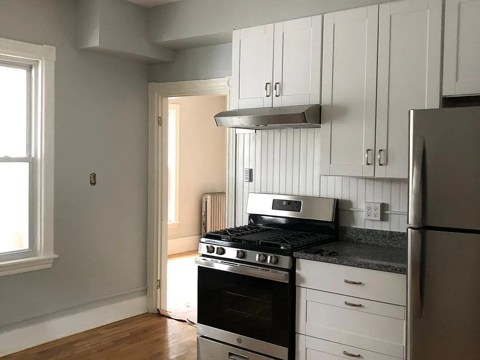 Bright, spacious eat-in kitchen with new cabinetry, appliances, and newly refinished hardwoods throughout apartment