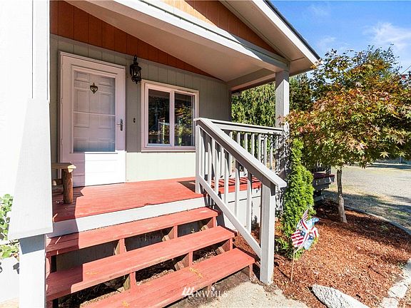 Cute country porch welcomes you. Great spot for a rocking chair and sipping morning coffee!