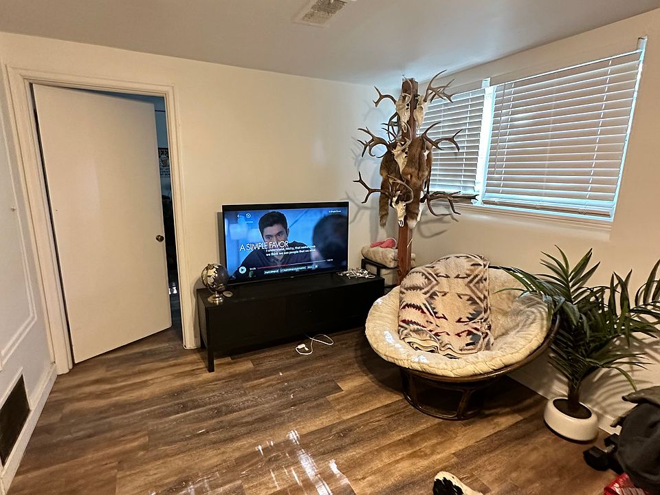 Main living area. Ceiling fan, new paint, new blinds..