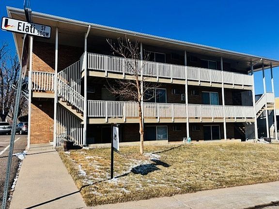 Bright, two-level urban apartment building with balconies and spacious surroundings on Elati Street.