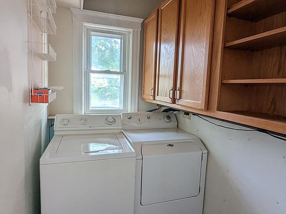 Laundry Room with in-unit washer and dryer with cabinets