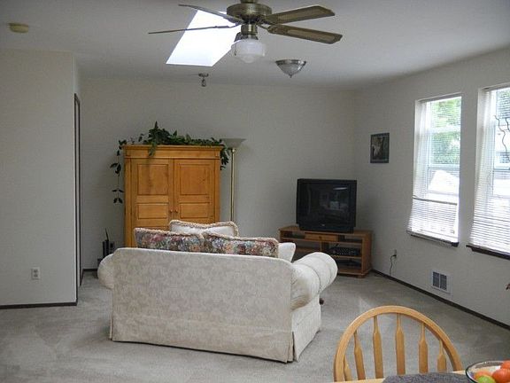 This is the other end of the family room with 2 skylights, lots of windows and ceiling fans. Wired f