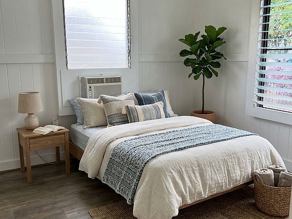 Bedroom with window ac unit (photo is staged with furniture that's not included)