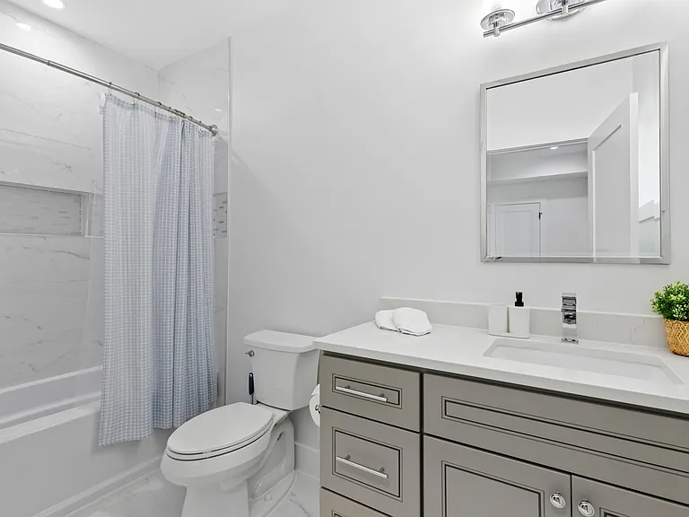 Bathroom B with a shower and tub in bedroom B