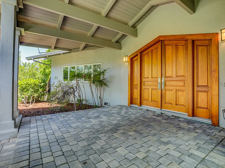 Spacious multi-level 8,000 square foot 5-bedroom 5.5-bath house situated in a sprawling one-acre lot in Los Altos Hills featuring various entertainment spaces.