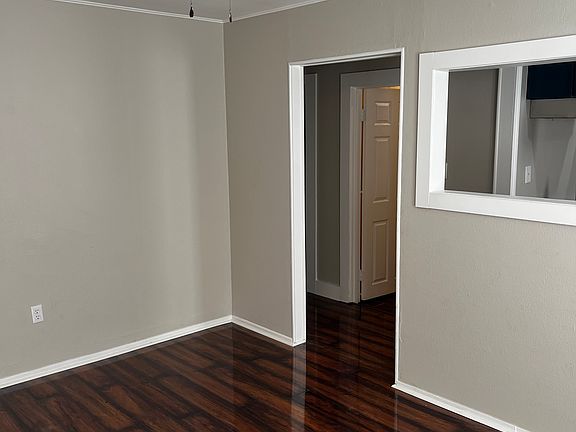 Living room looking into hallway and bathroom door