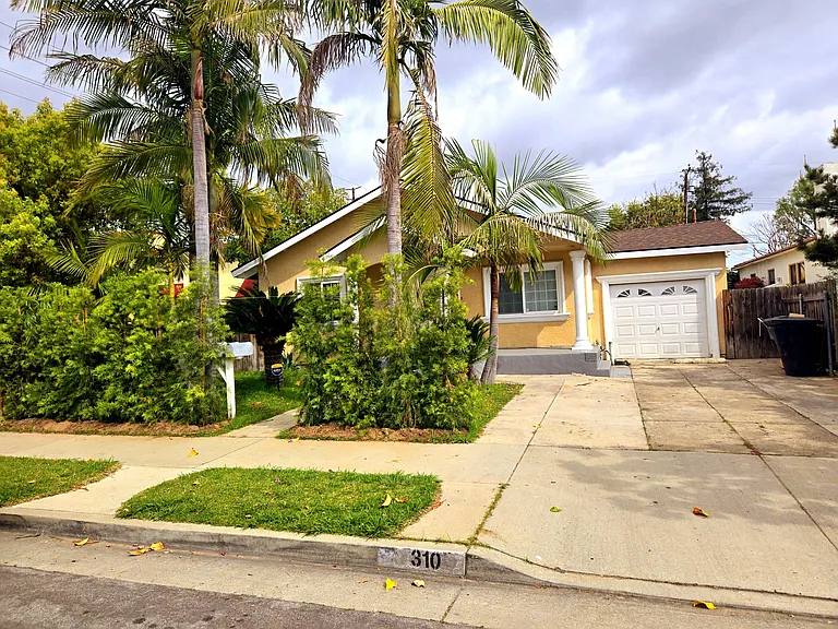 Front view of house with private hedges making it more private in the front