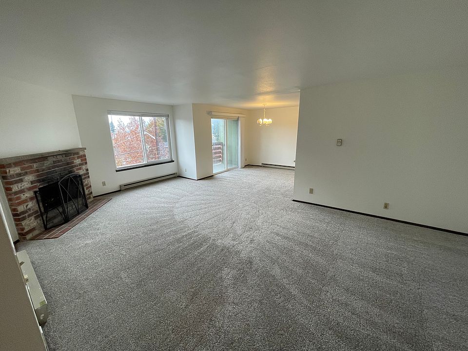Large bright living room with fireplace annd bonus area. Open floor plan.