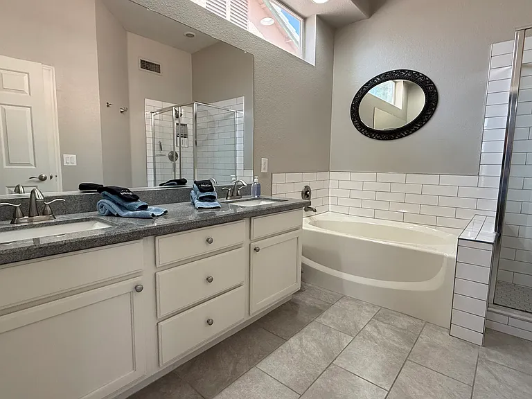 Master bath. Double vanity sink, soaking tub, and walk-in in subway tie shower.