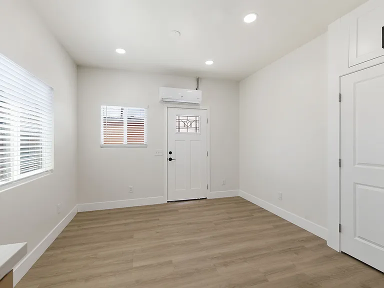 View from kitchen to entrance shows Mini Split AC system above front door