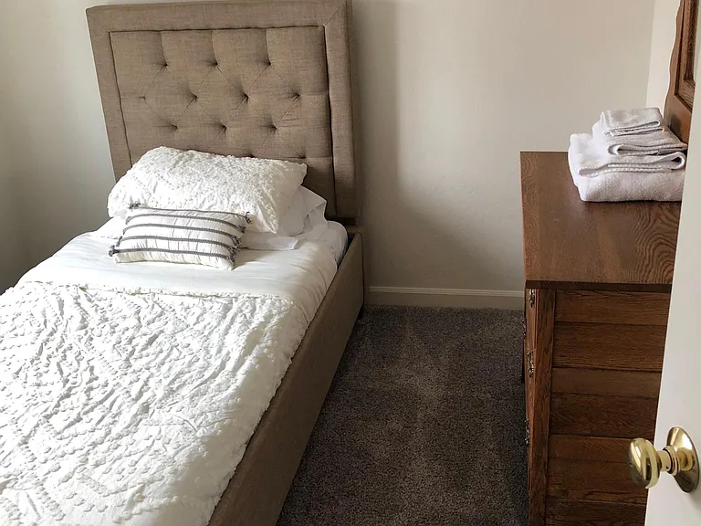 Twin bed with mirror over dresser