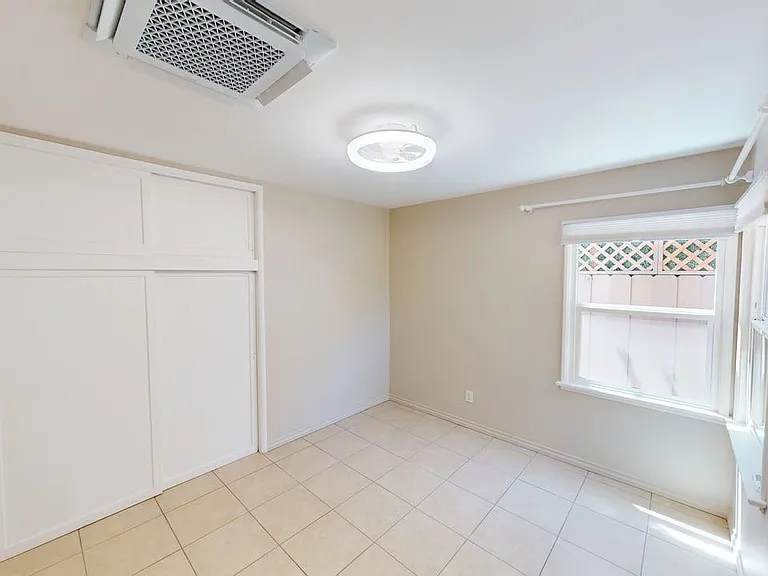 main bedroom showing ceiling HVAC mini-split system and light/fan combo