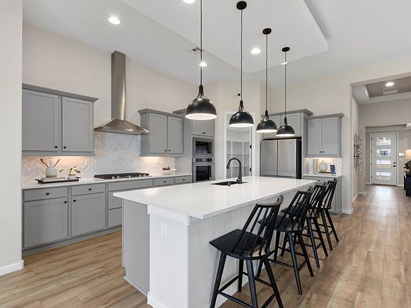 Award-winning Parklane home design is popular for the open gathering room, kitchen, cafe, and patio