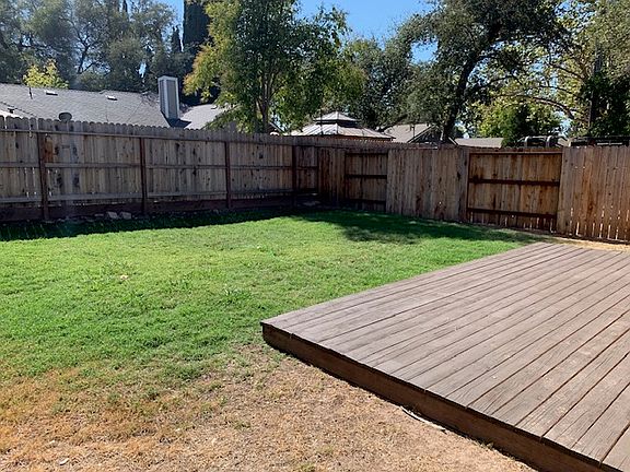 Back yard with a wood deck.