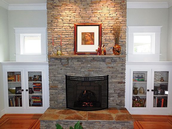 Spectacular Stackstone ventless fireplace, flanked by custom built-ins