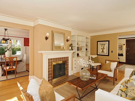 The living room with scones, built-ins and tiled fireplace