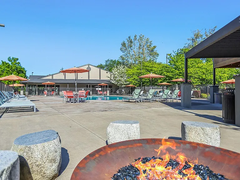 Experience the perfect blend of relaxation and style at this luxurious outdoor pool area.