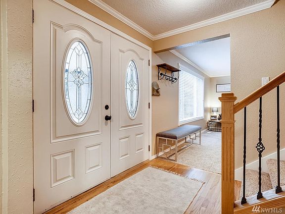 Beautiful entry with double door entry, rich hardwoods and new stair railing.