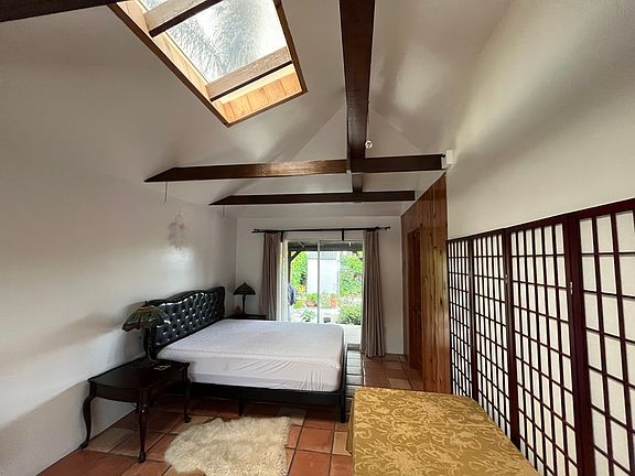bedroom with skylight and patio glass sliding door
