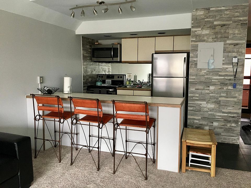 Updated kitchen with stainless steel appliances and ample counter space