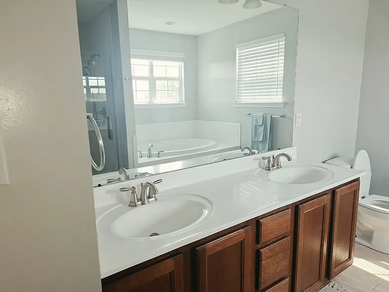Enjoy a spacious en-suite bathroom featuring a double vanity, soaking tub, and separate shower for added comfort during your stay.