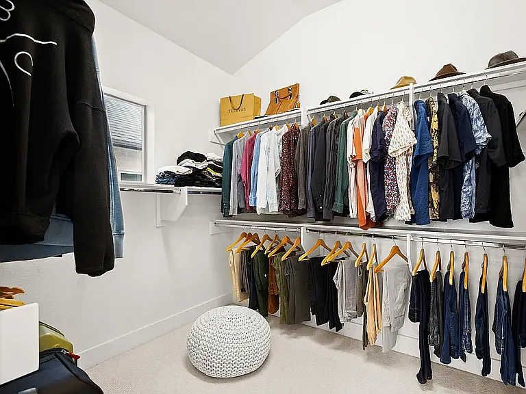 The enormous walk-in closet feels like its own room, complete with abundant shelving and storage for every wardrobe.