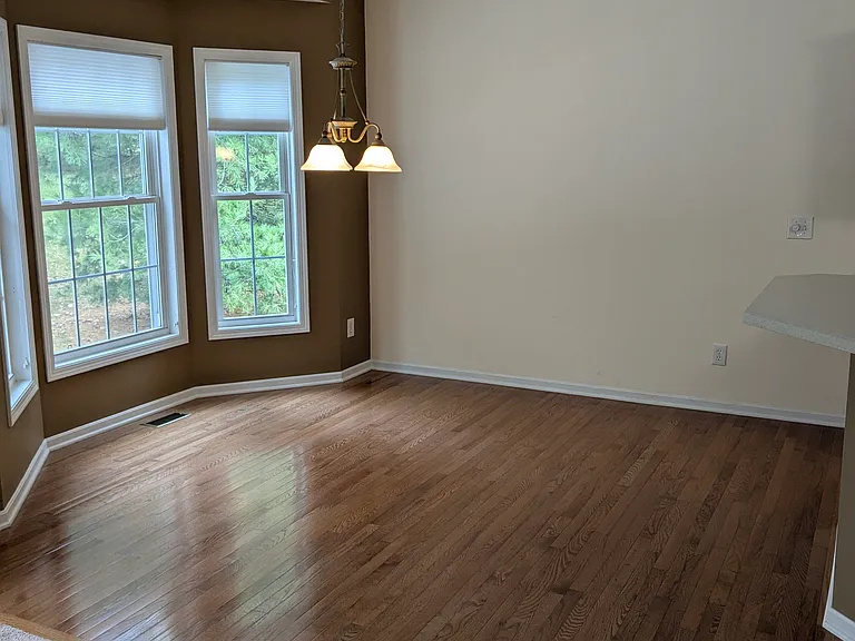 Dinette off kitchen has hardwood floors