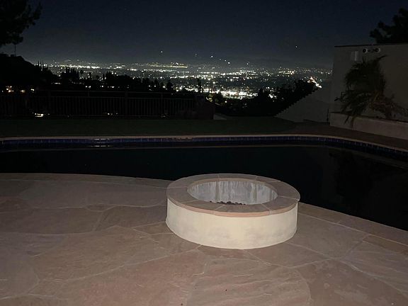 Night view from the back yard fire pit and pool