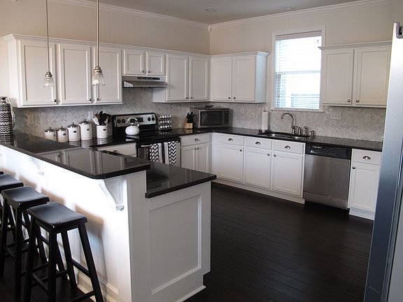 Designer remodeled kitchen with granite countertops & marble backsplash