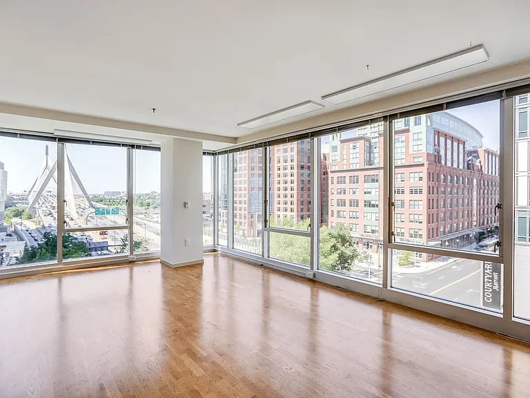 Floor to ceiling windows with views of the Zakim Bridge, Boston Harbor and Downtown