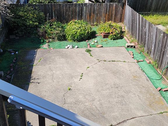View of backyard area accessible with exterior stairs from outdoor deck