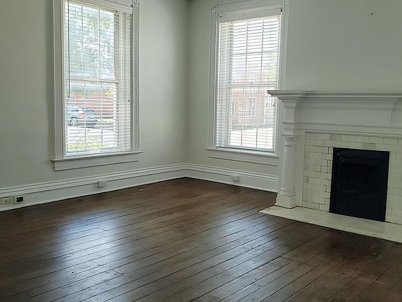 Living room with high ceilings, and 5 large windows provides plenty of natural light.