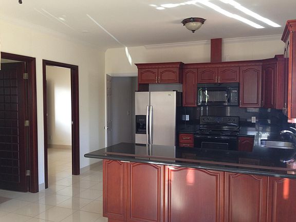 Kitchen with black granite counter