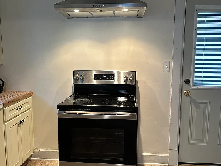 Stainless/black stove and brand new hood.