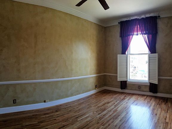 Living Room with 11 foot ceilings, new high efficiency windows, and plantation shutters.