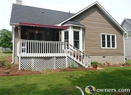 Back South View of house. New Awning on deck. All new windows